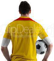 Football player in yellow holding ball