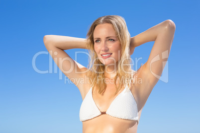 Beautiful blonde in white bikini on the beach