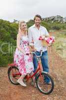 Cute couple going for a picnic smiling at camera