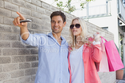 Stylish young couple walking with shopping bags