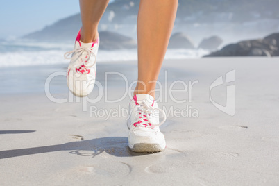 Fit woman walking on the beach