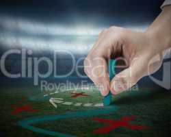 Hand drawing tactics on football pitch