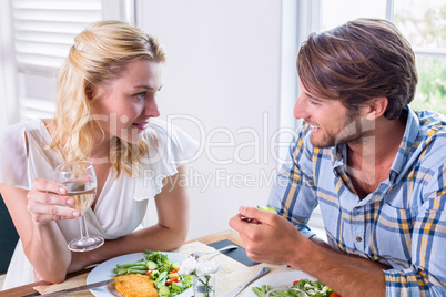 Cute smiling couple enjoying a meal together