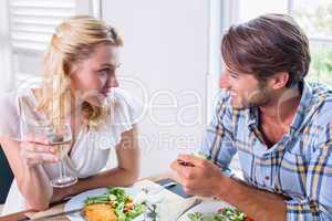 Cute smiling couple enjoying a meal together