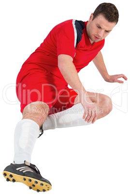 Football player in red kicking