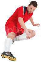 Football player in red kicking