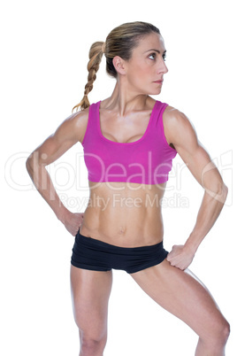 Female bodybuilder posing in sports bra and shorts