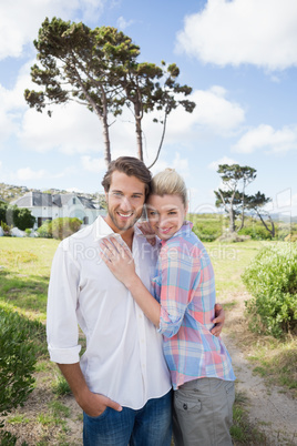 Smiling couple standing outside together in their garden