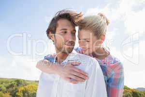 Smiling couple standing outside together