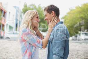 Hip young couple smiling at each other