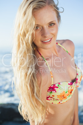 Gorgeous blonde in floral bikini posing at the beach