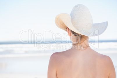 Woman in sunhat looking out to sea