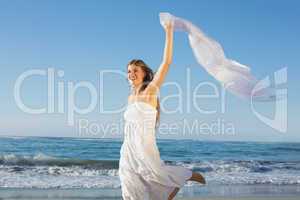 Beautiful blonde in white sundress on the beach with cocktail