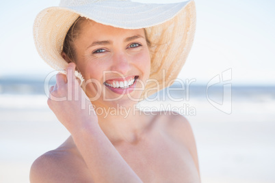 Woman in sunhat looking out to sea