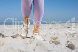 Sporty womans feet on the sand