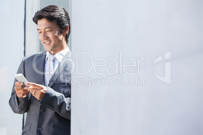 Asian businessman sending text message