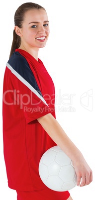 Cute football player standing with ball