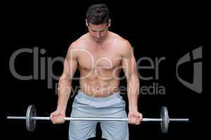 Serious crossfitter lifting up barbell