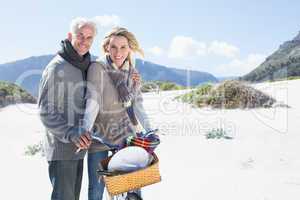 Carefree couple going on a bike ride and picnic on the beach