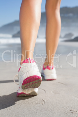 Fit woman walking on the beach