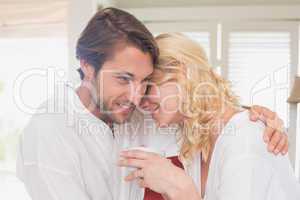 Couple having breakfast in their bathrobes