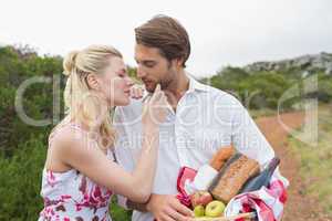 Cute couple going for a picnic about to kiss