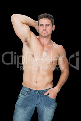 Handsome muscular man posing in blue jeans