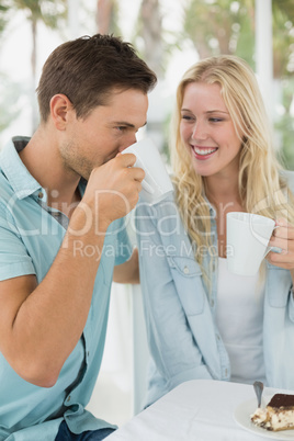 Hip young couple having coffee together