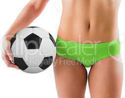 Fit girl in green bikini holding football