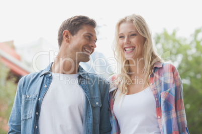 Hip young couple laughing together