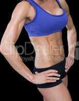 Female bodybuilder posing with hands on hips mid section