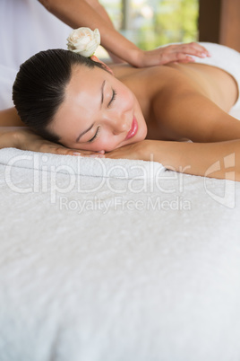 Brunette enjoying a peaceful massage with eyes closed