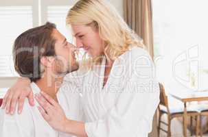 Couple having breakfast in their bathrobes