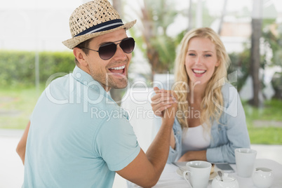 Hip young couple having coffee together