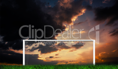 Football goal under sunset cloudy sky