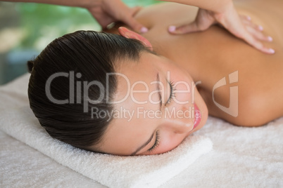 Brunette enjoying a peaceful massage with eyes closed