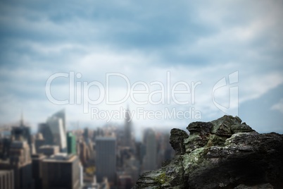 Large rock overlooking big city