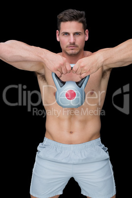 Focused bodybuilder swinging up kettlebell Focused bodybuilder swinging up kettlebell
