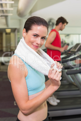 Smiling brunette with towel over shoulders