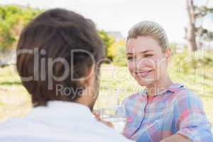 Cute couple sitting in the garden enjoying wine together