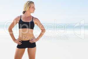 Fit blonde standing on the beach