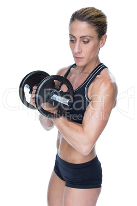 Female strong bodybuilder holding large black dumbbell