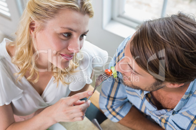 Cute smiling couple enjoying a meal together