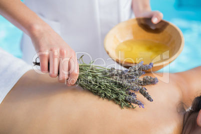 Woman getting an aromatherapy treatment poolside