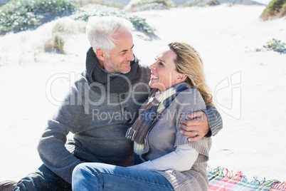 Carefree couple having picnic on the beach