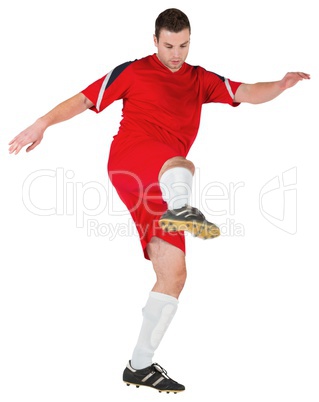 Football player in red kicking