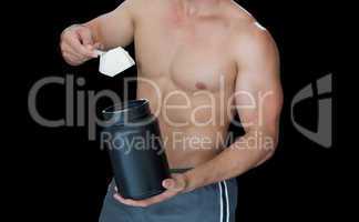 Muscular man scooping up protein powder