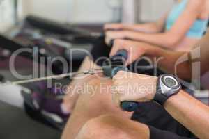 Man and woman working out on the rowing machine