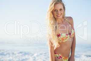 Gorgeous blonde in floral bikini posing at the beach