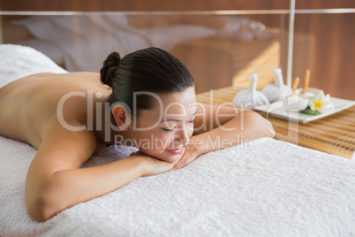 Content brunette relaxing on massage table